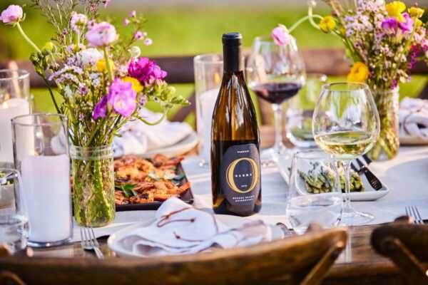 Olema Chardonnay Reserve on a beautifully set table with grilled food