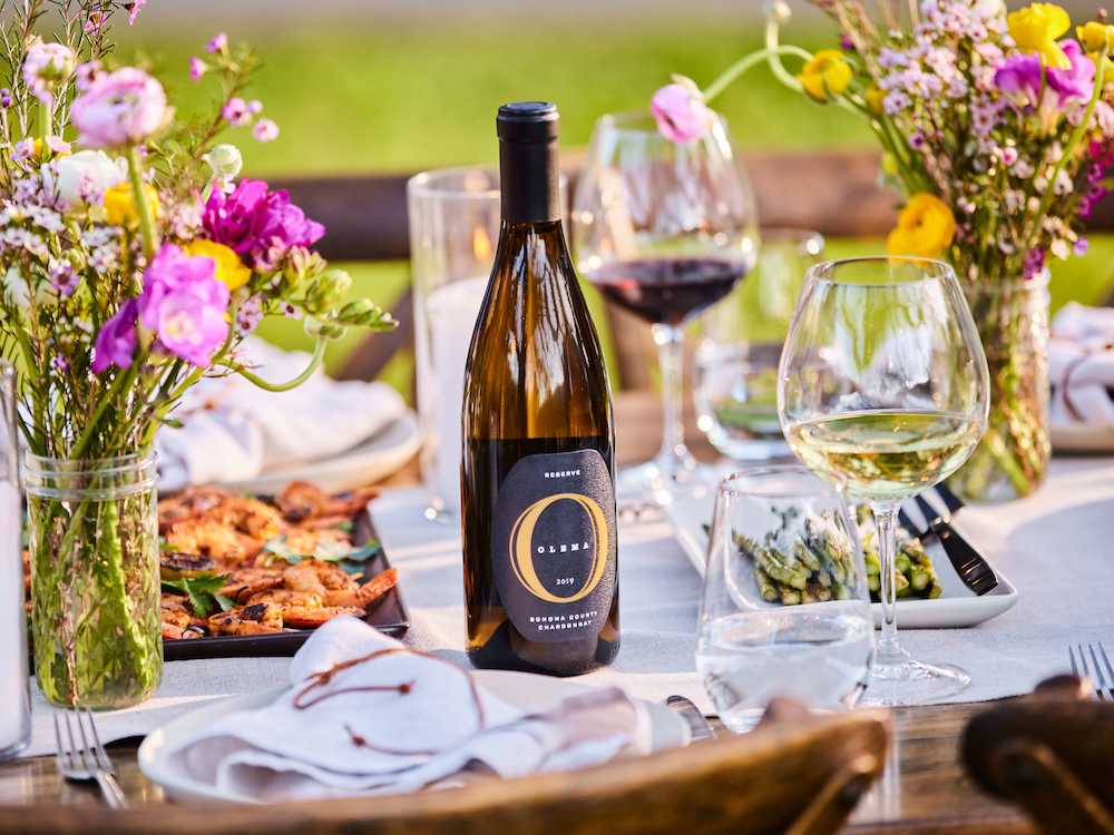 Image of Olema Chardonnay Reserve on a set table in summertime
